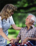 Nurse assisting a gentleman in a wheelchair